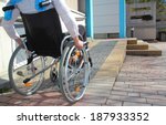 Woman In A Wheelchair Using A...