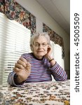 Elderly Woman Concentrating And ...