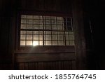 Small photo of View of the old window in the military barracks. A ray of sunshine through the window. An image of decrepitude or natural disaster