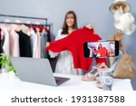 young woman selling clothes online by smartphone live streaming, business online e-commerce at home