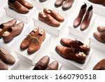 From above clean elegant shoes made of brown leather and placed on white containers