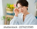 Small photo of Hay fever image of a young woman scratching her eyes
