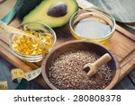 Sources of omega 3 fatty acids: flaxseeds, avocado, oil capsules and flaxseed oil