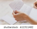 Hands of young woman holding handwritten letter 