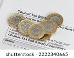 Small photo of New pound coins on a council tax bill