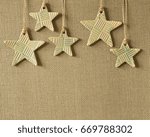 Small photo of 5 Pottery stars on a olive brown burlap background