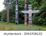 Colored and traditional totem poles in Stanley Park in Vancouver