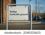 Small photo of Sign at the entrance of a company premises with the German inscription Fachkrafte gesucht. Translation: Skilled workers wanted