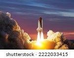 Small photo of Spaceship lift off. Space shuttle with smoke and blast takes off into space on a background of sunset. Successful start of a space mission. Elements of this image furnished by NASA.