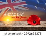 Small photo of Poppy pin for Anzac Day. Poppy flower on old beautiful high grain, detailed wood on background of sunset sky and transparent Australia flag. Anzac Day Lest We Forget.