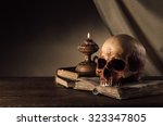 Human Skull  Lit Candle And...