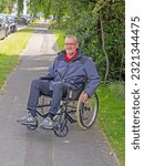 Small photo of Knutsford, Cheshire, UK. 2nd June 2023. Customer in self propelled wheelchair hired from the Red Cross Mobility Aids Service, Knutsford, Cheshire, UK