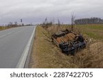 Small photo of car wreck lying in a roadside ditch
