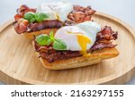 Small photo of Ciabatta sandwich with poached egg and bacon