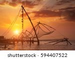 Small photo of Kochi chinese fishnets on sunset. Fort Kochin, Kochi, Kerala, India. With lens flare and light leak