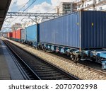 Small photo of train wagons with containers for the transport of goods stopped on a train station,distribution and goods transportation using railroads, global crisis of containers that impede supply