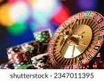 Small photo of Casino theme. High contrast image of casino roulette, poker game, dice game, poker chips on a gaming table.