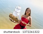 Woman In Red Dress Holding Boat ...