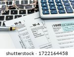 Financial time tax form with laptop and calculator. Office paperwork. Accounting