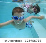 Boy And Girl Swimming Underwater