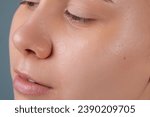 Small photo of Girl with acne stick round acne patch on her cheek. Using acne patches for treatment of pimple and rosacea close-up. Facial rejuvenation cleansing cosmetology