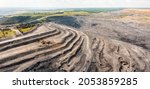 Small photo of Panoramic aerial view of coal mine. Open pit mine industry, big yellow mining truck for coal quarry. Open coal mining anthracite mining. Pit on coal mining by open way. Rock loading in trucks