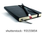 Black pen with pink rubber on black leather moleskin notebook isolated on white.