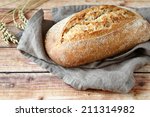 loaf of bread on wooden background, food closeup