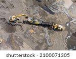 Small photo of Aerial top view of the stone crusher conveyor belt heavy excavators loading stones into the crusher with heavy equipment machines