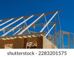 An construct wooden roof beam from framework of trusses frames for newly constructed stick house