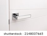 Small photo of Door handles elements close up. Door handle on white closed doors in modern loft style in interior. Concept of accessories for interior design home interior of apartment or office.