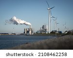 Small photo of Fossil fuel (coal) power station and wind turbines in the Eemshaven generating power. Energy transition concept.