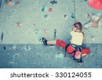 Little Girl Climbing A Rock...