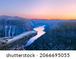 Alone tourist on Trolltunga rock - most spectacular and famous scenic cliff in Norway - Landscape