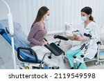 Small photo of Concentrated gynecologist listening to her patient complaints