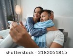 Small photo of Guy with slight indisposition in bed in company of his girlfriend
