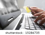 Image of hands holding credit card and pressing a keys of  keyboard