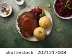 Traditional German roasted beef with potato dumplings and cabbage