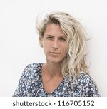 Small photo of Beautiful blowzy blonde hair woman portrait, outdoor, white background