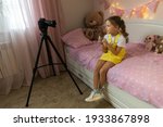 a little girl has her own video ... | Shutterstock . vector #1933867898