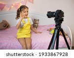 a little girl has her own video ... | Shutterstock . vector #1933867928