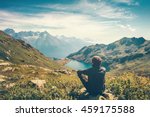Traveler Man relaxing meditation with serene view mountains and lake landscape Travel Lifestyle hiking concept summer vacations outdoor 