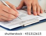 Close up of male accountant filling tax form. Man writing something sitting at his office. Filling individual income tax return form 1040, making financial report, home finances or economy concept