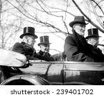 Small photo of President Warren G. Harding (1865-1923) riding open convertible to his inauguration with Presidential Woodrow Wilson (1856-1924), March 4, 1921. In front seats are Joseph Cannon and Philander Knox.