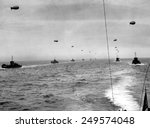 On the English Channel, a convoy in two lines of landing craft head for Utah Beach on D-Day. The craft traveled in paths cleared of mines before the invasion. June 6, 1944.
