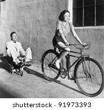 Woman On A Bicycle Pulling A...