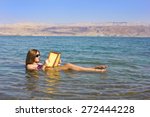 Beautiful Young Woman Reads A...