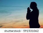 Woman Praying Silhouette At...