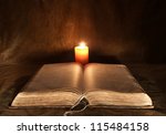 Opened Bible And Candle