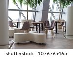 empty cafe in the airport chairs and tables, modern building